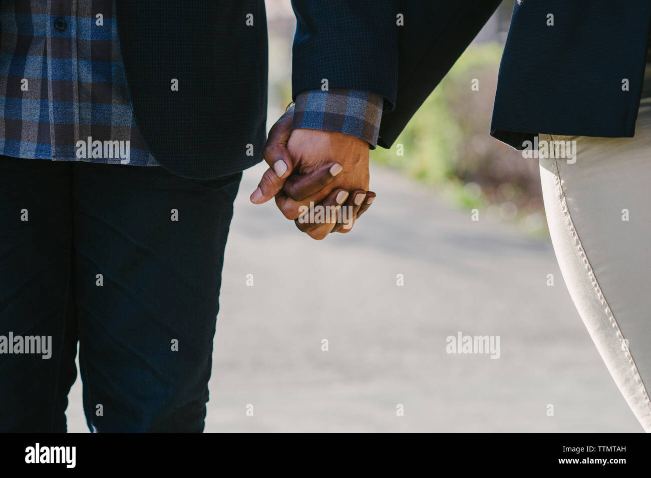 Smart couple holding hands hi-res stock photography and images - Alamy