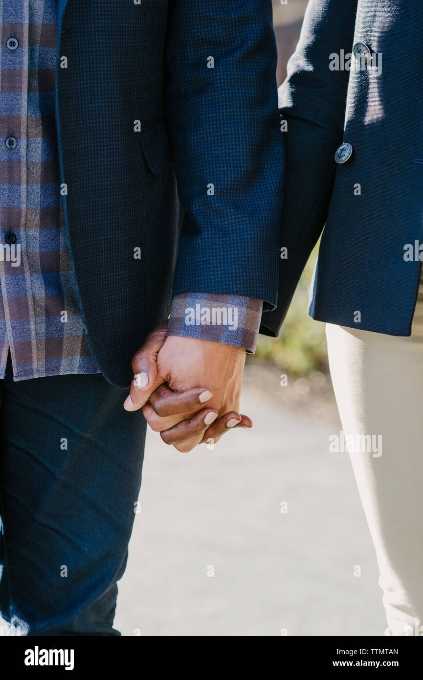 Smart couple holding hands hi-res stock photography and images - Alamy
