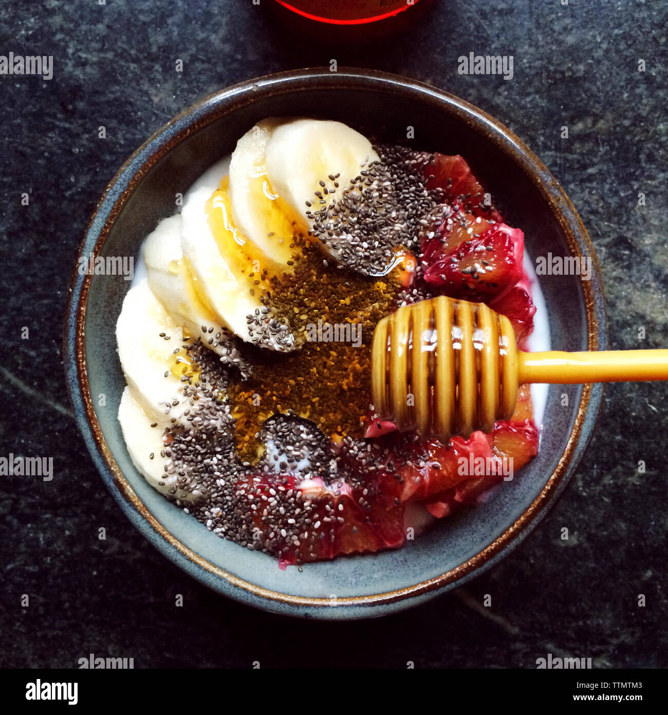 Bowl of fruits with honey and seeds Stock Photo