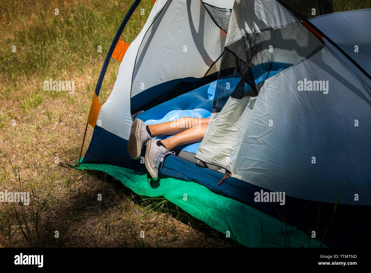 Legs of man in tent Stock Photo