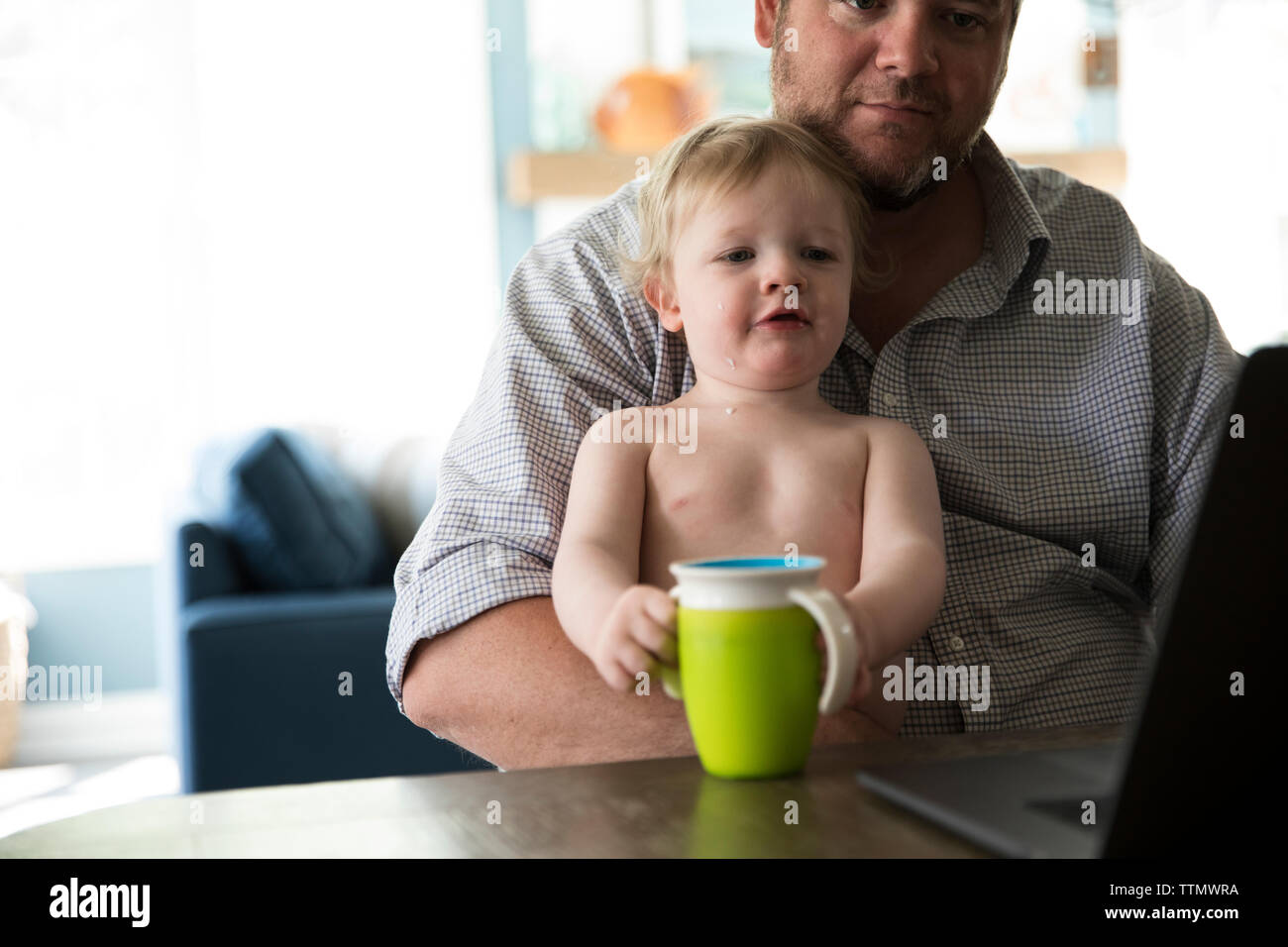 Dad working on laptop toddler hires stock photography and images Alamy