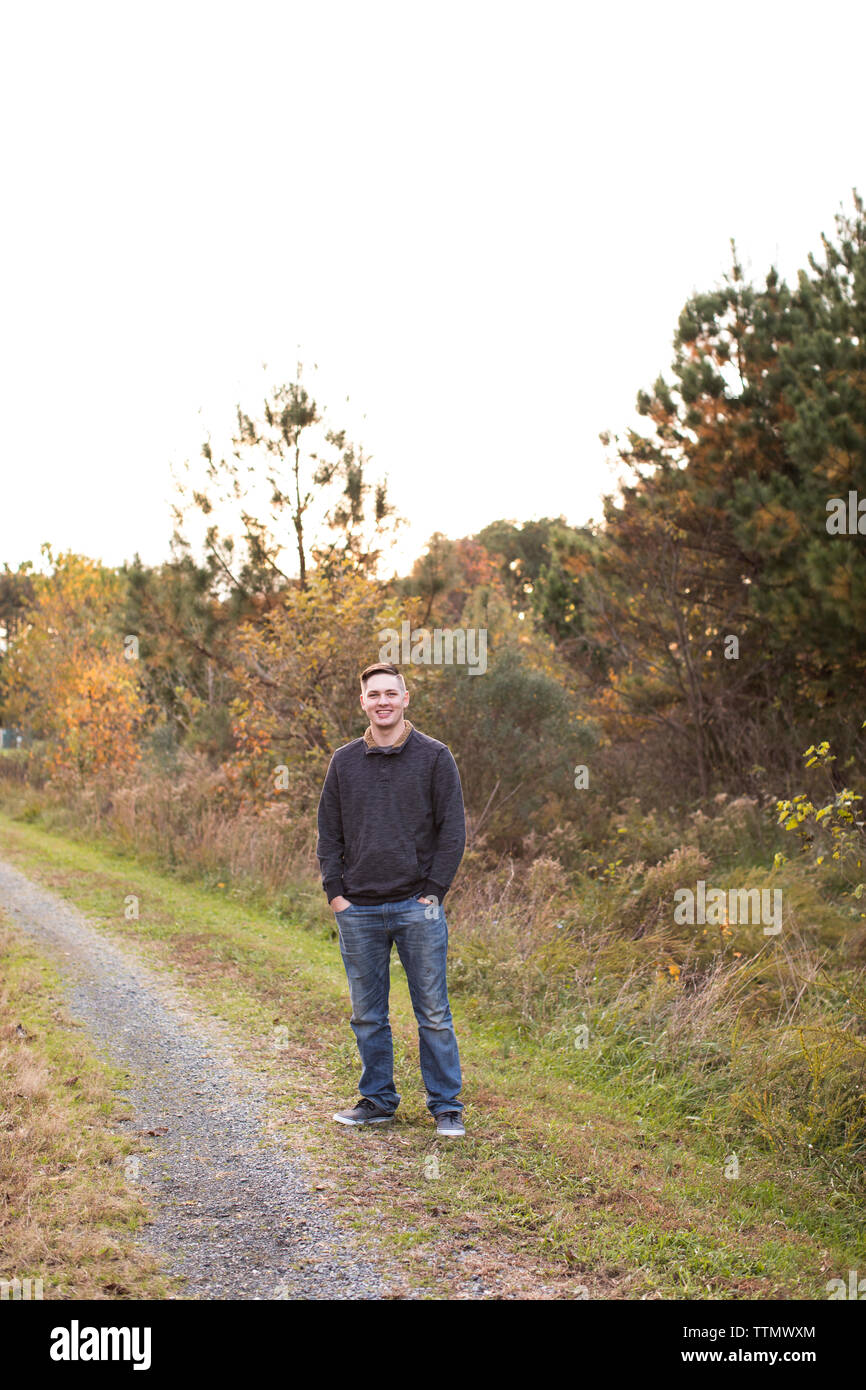 Smiling 13 Year Old Girl Stands Confidently at Sunset on Trail Stock Photo