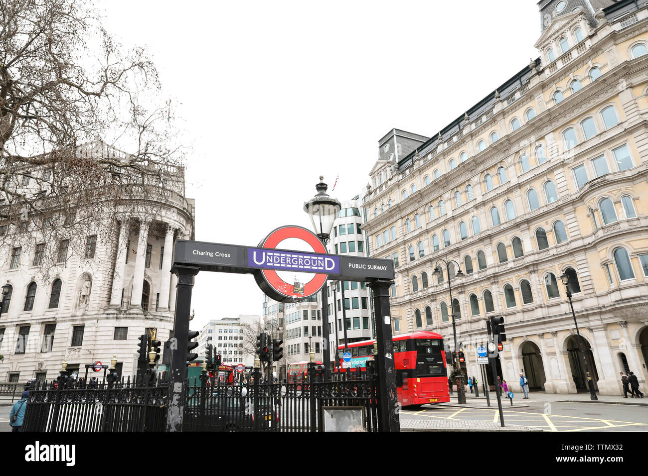 London Street View of Underground Sign and Red Double Decker Bus Stock Photo