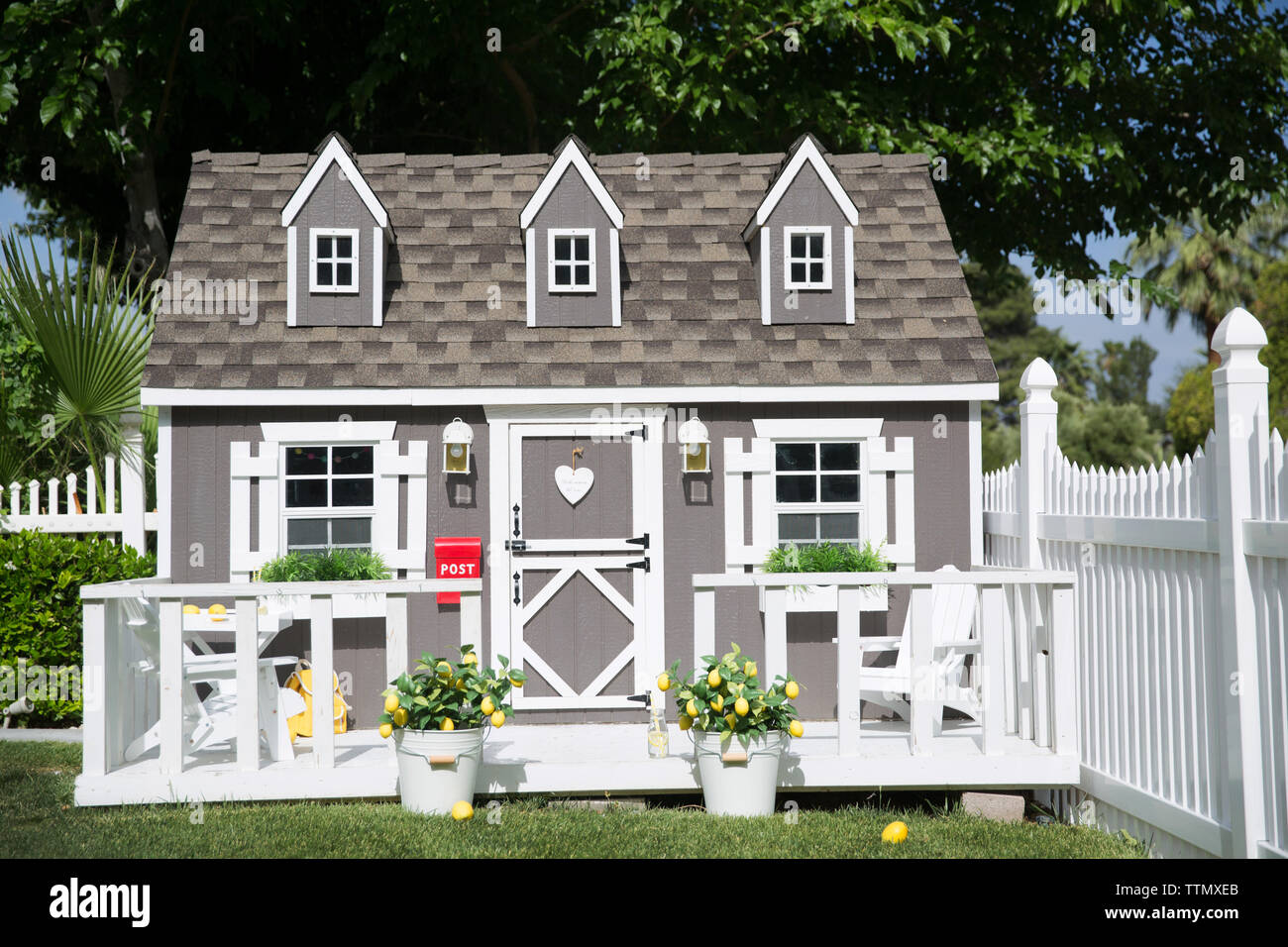 Playhouse on grassy field at yard during sunny day Stock Photo Alamy