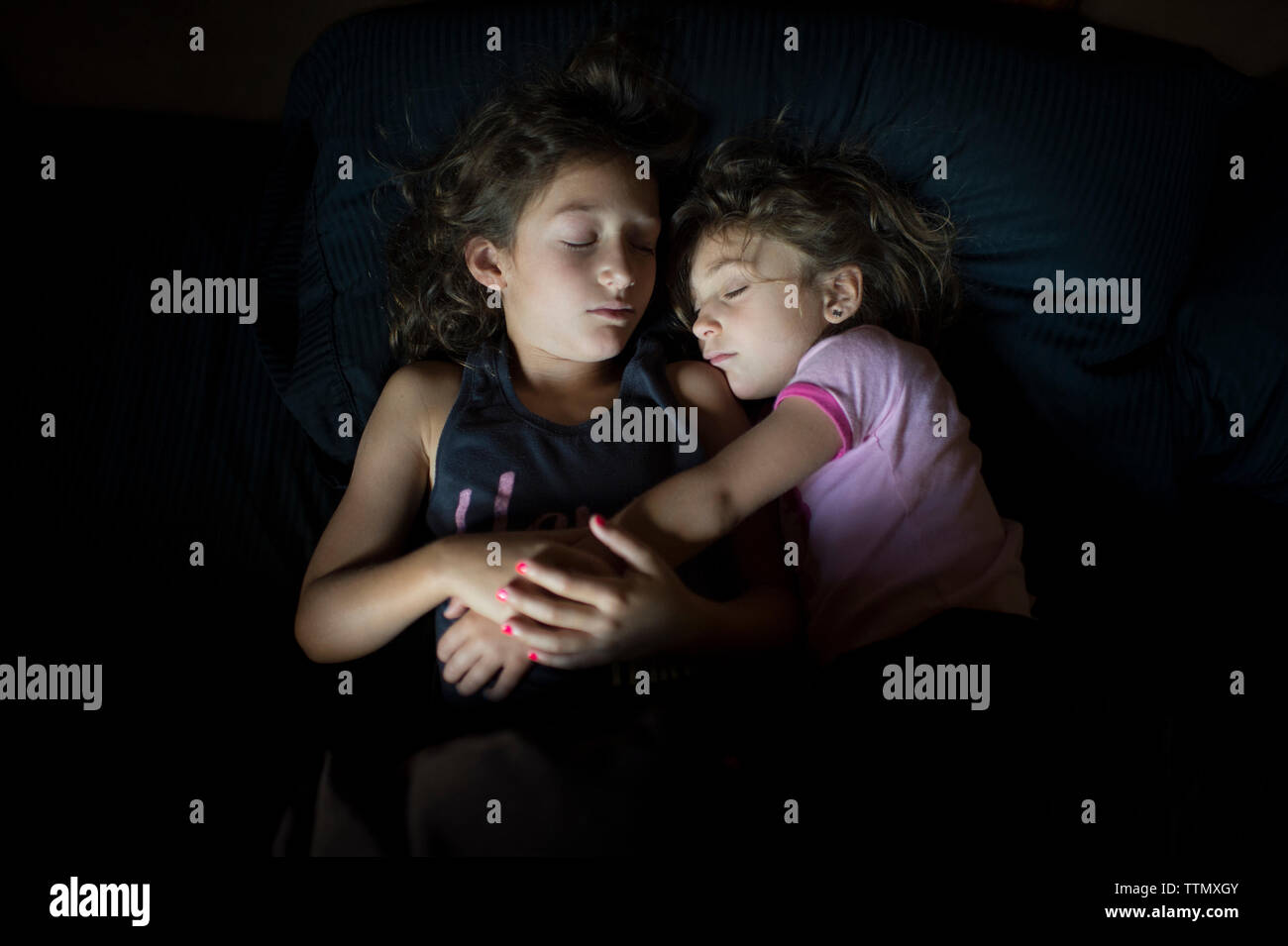 High angle view of sisters sleeping on bed at home Stock Photo Alamy