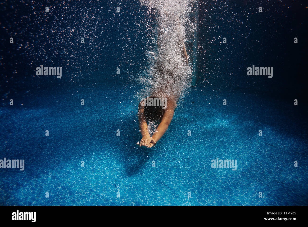 Boy diving in swimming pool Stock Photo