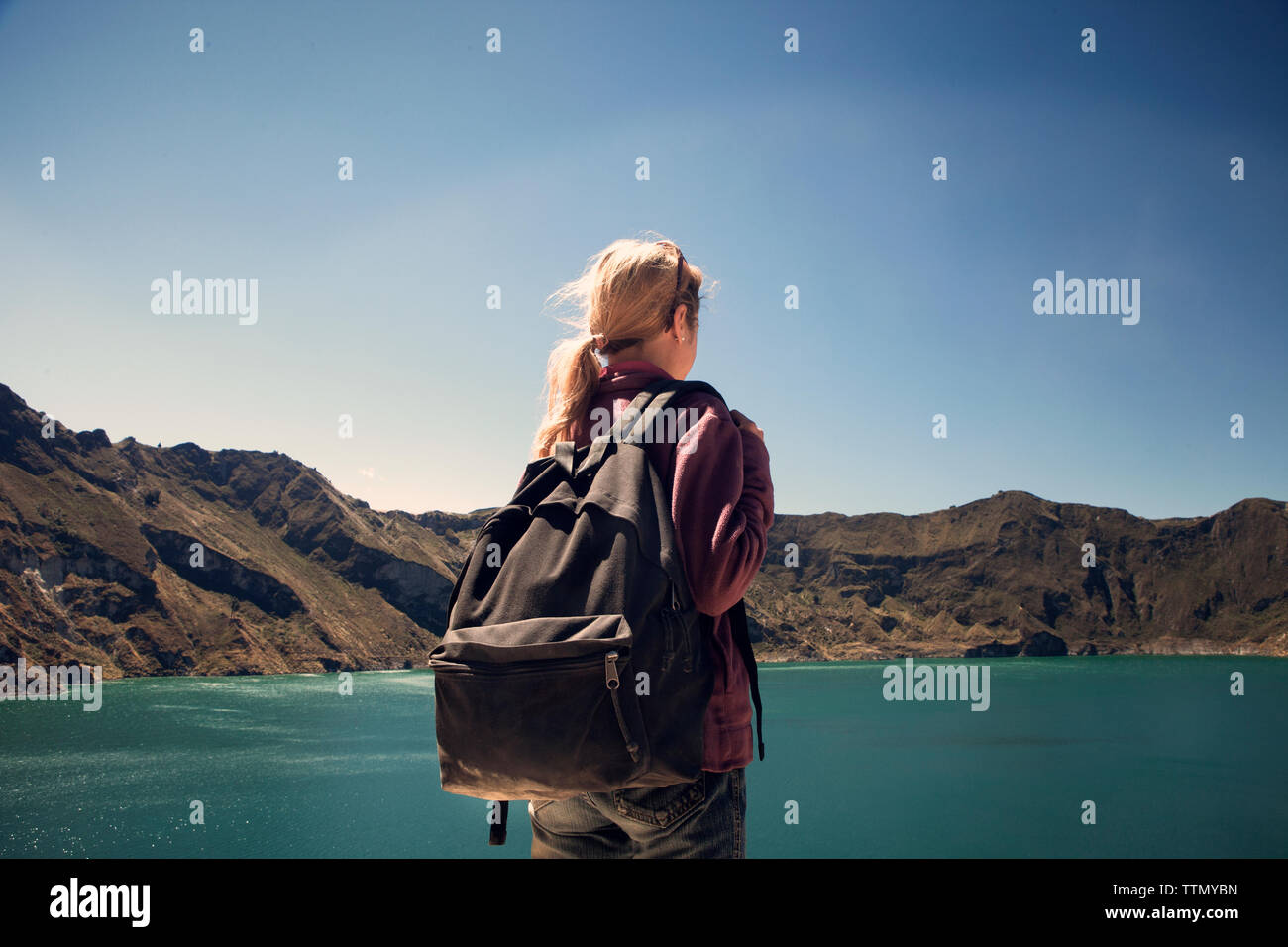 Rear view of female hiker against lake and mountains Stock Photo - Alamy