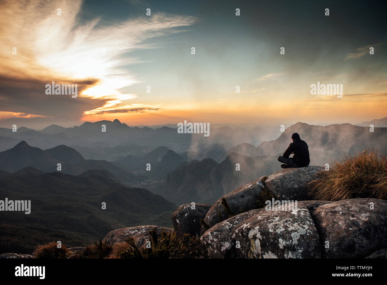 Man watching sunset sitting on hi-res stock photography and images - Alamy