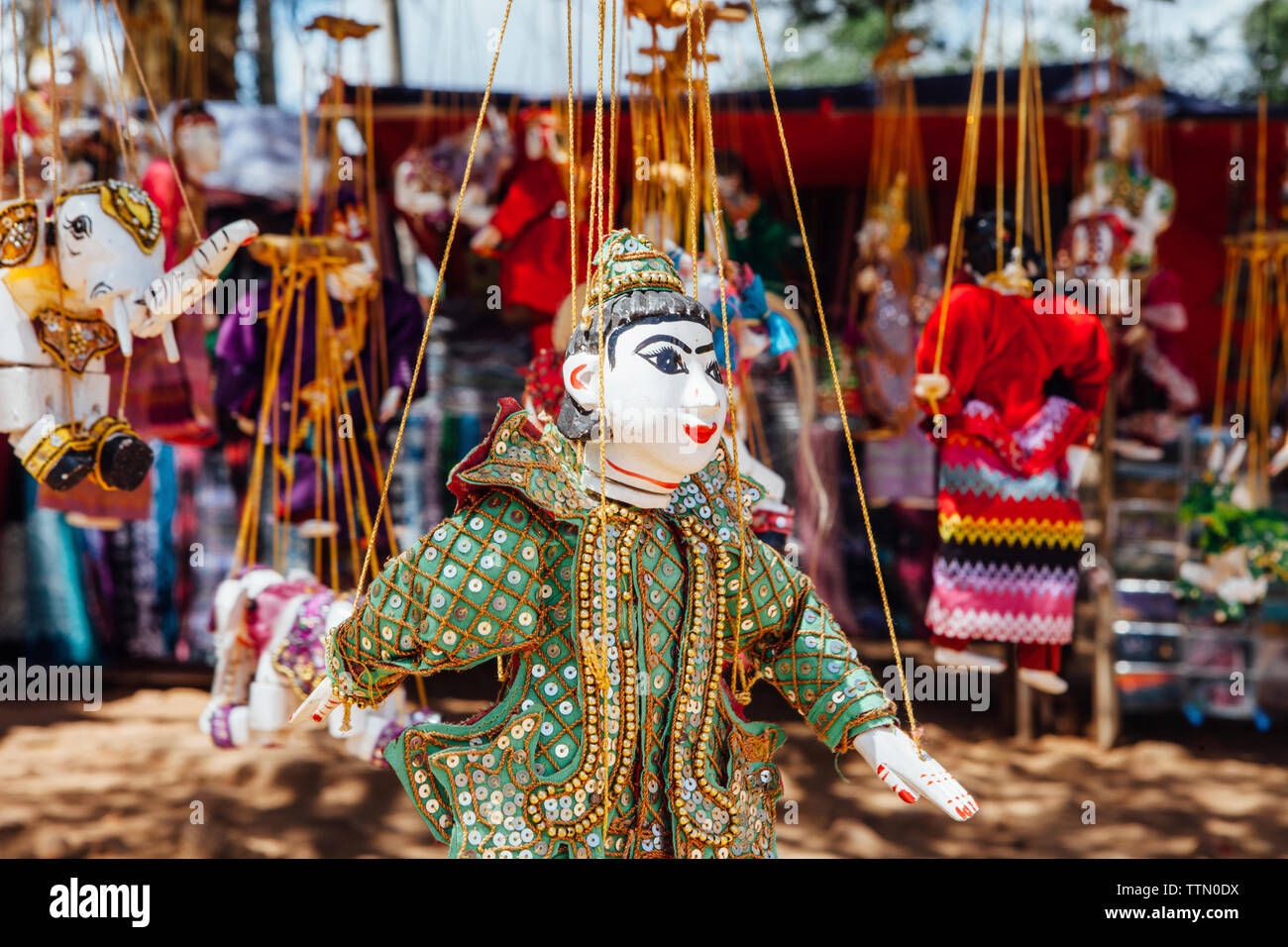 Puppets hanging for sale at market Stock Photo