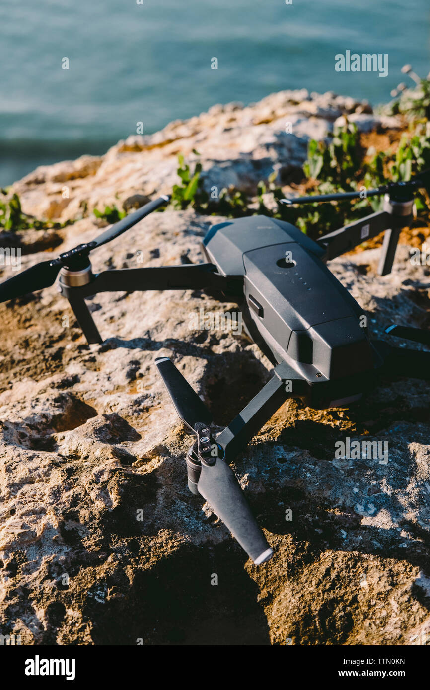 High angle view of quadcopter on rock formation during sunset Stock Photo
