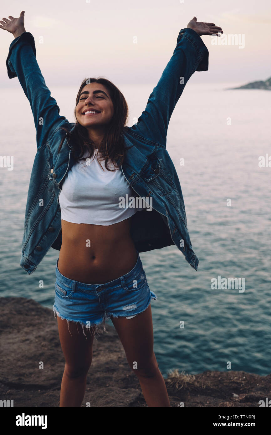 Woman standing sea raised arms hi-res stock photography and images - Alamy