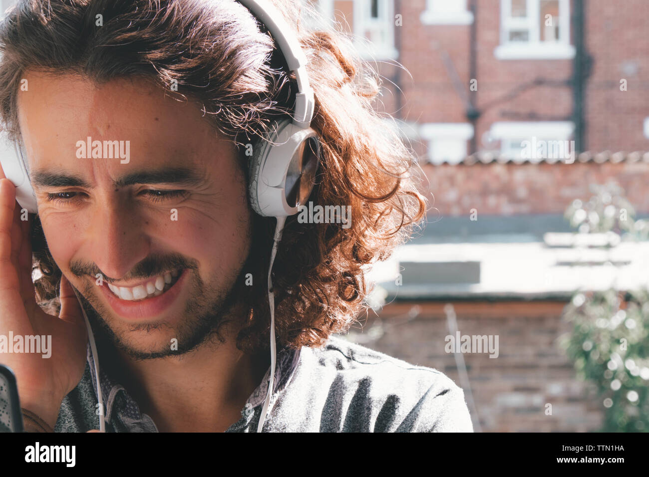 Caucasian listening music with white headphones Stock Photo