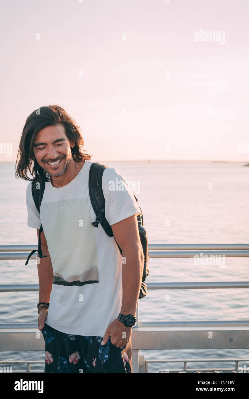 Brazilian laughing on a pier at the sunset with sea views Stock Photo