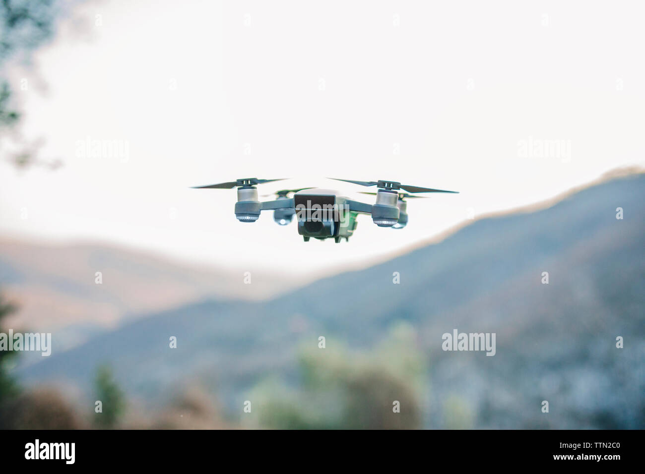 Close-up of quadcopter flying against clear sky Stock Photo