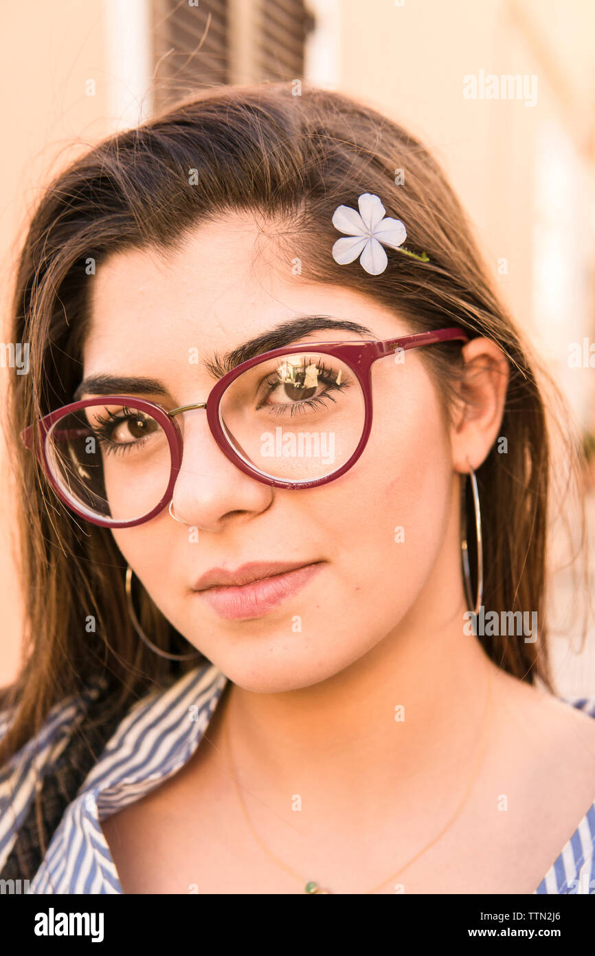 Close-up portrait of teenage girl wearing flower Stock Photo