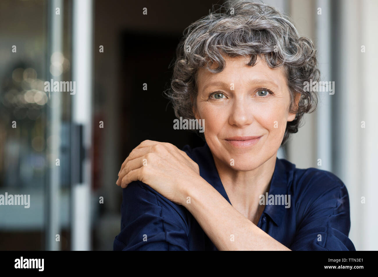Portrait of confident mature woman at home Stock Photo