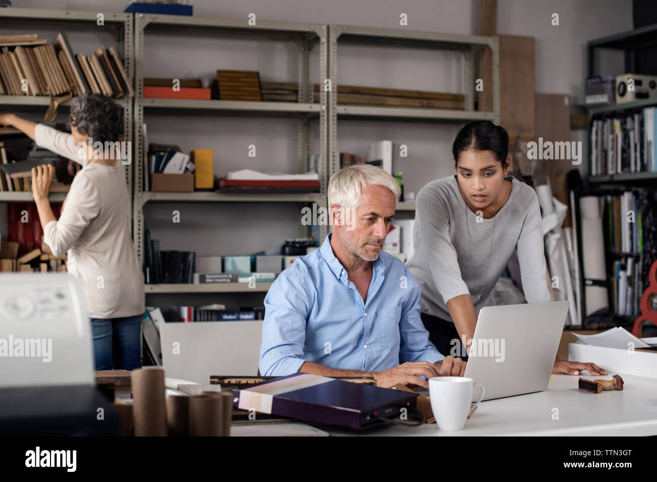 Multi-ethnic interior designers using laptop in creative office Stock Photo