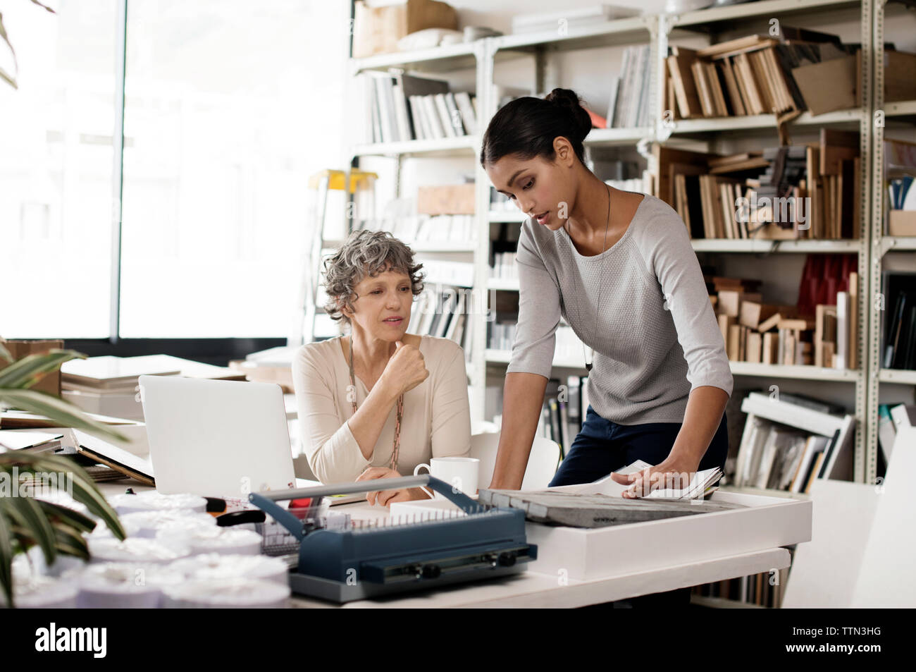 Interior designers discussing over tile sample in creative office Stock Photo