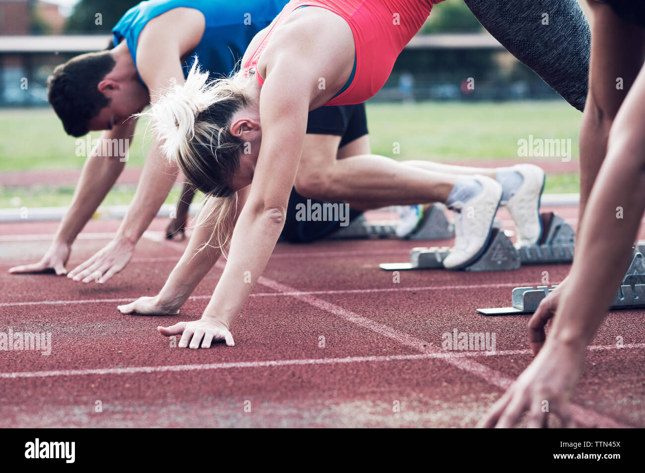 Athletes poised at starting blocks on track Stock Photo Alamy