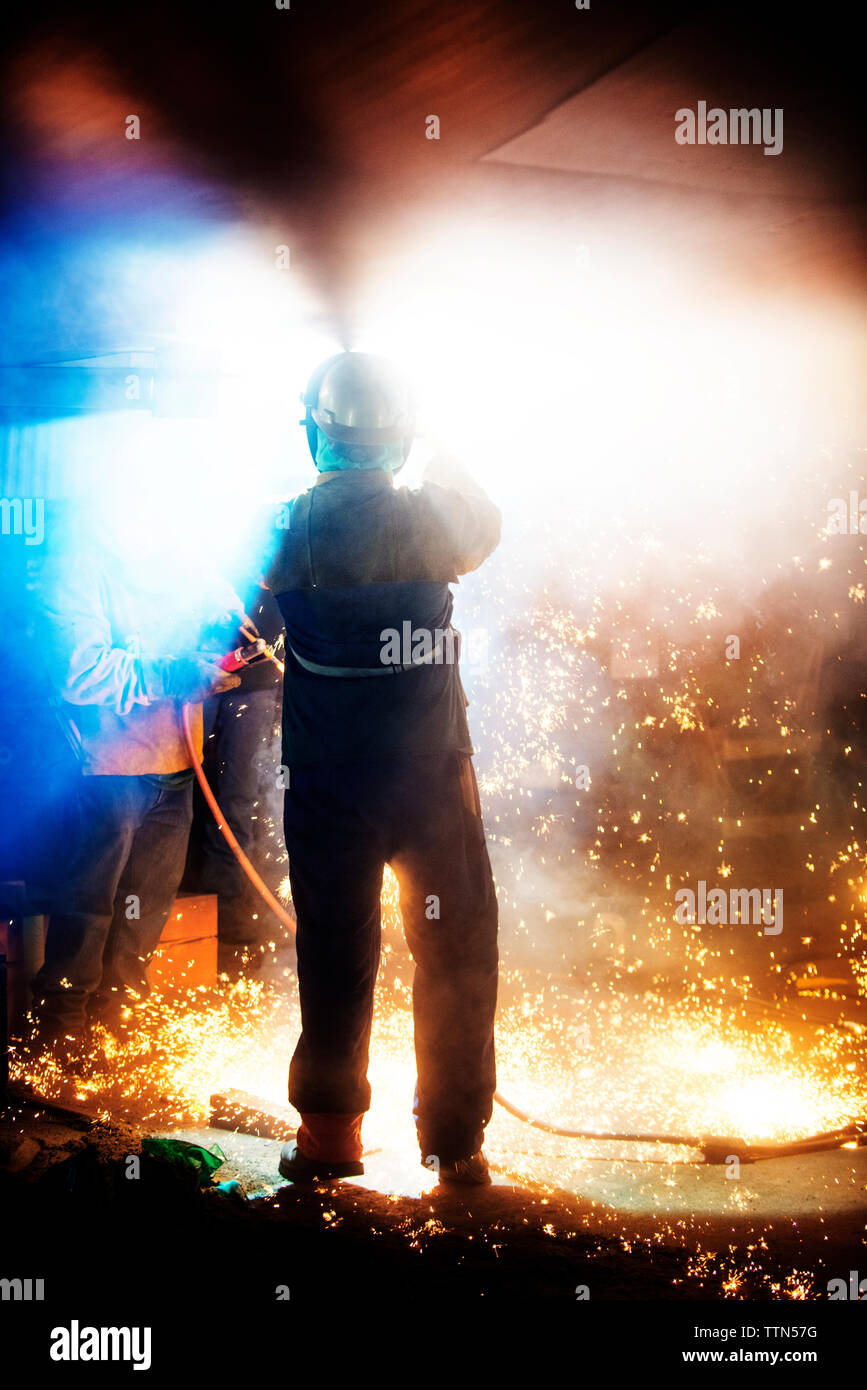 Workers welding airplane wing at industry Stock Photo