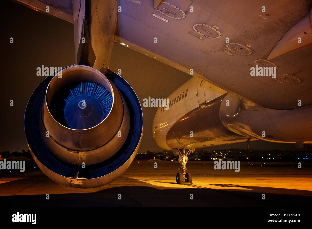 Close-up of jet engine at airport during night Stock Photo
