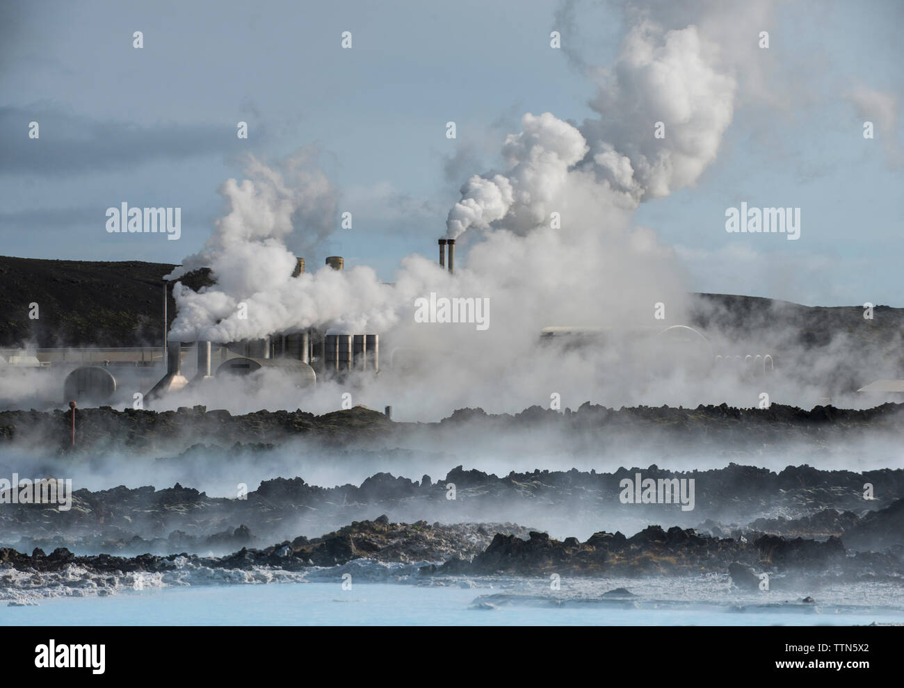 Smoke emitting from smokes tacks by sea Stock Photo