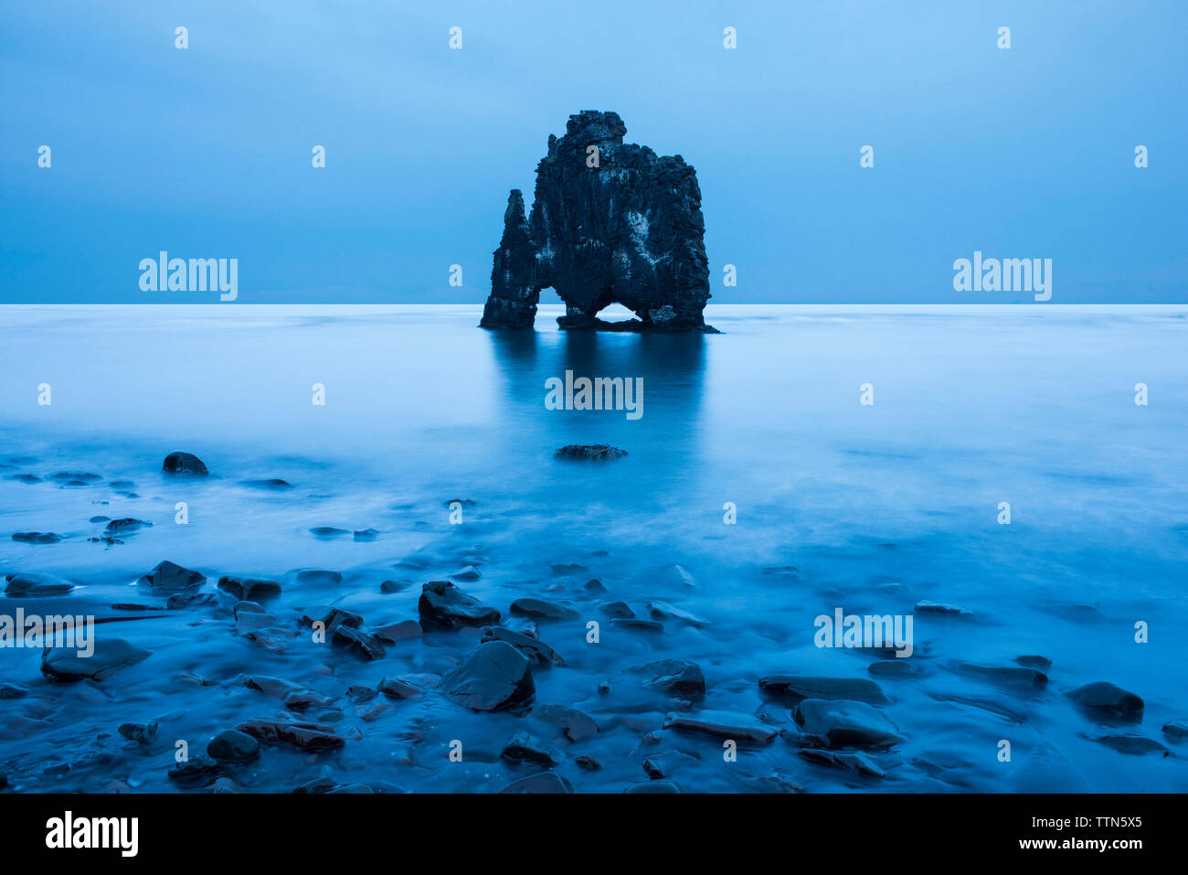 Rock formation in lagoon against clear blue sky Stock Photo - Alamy