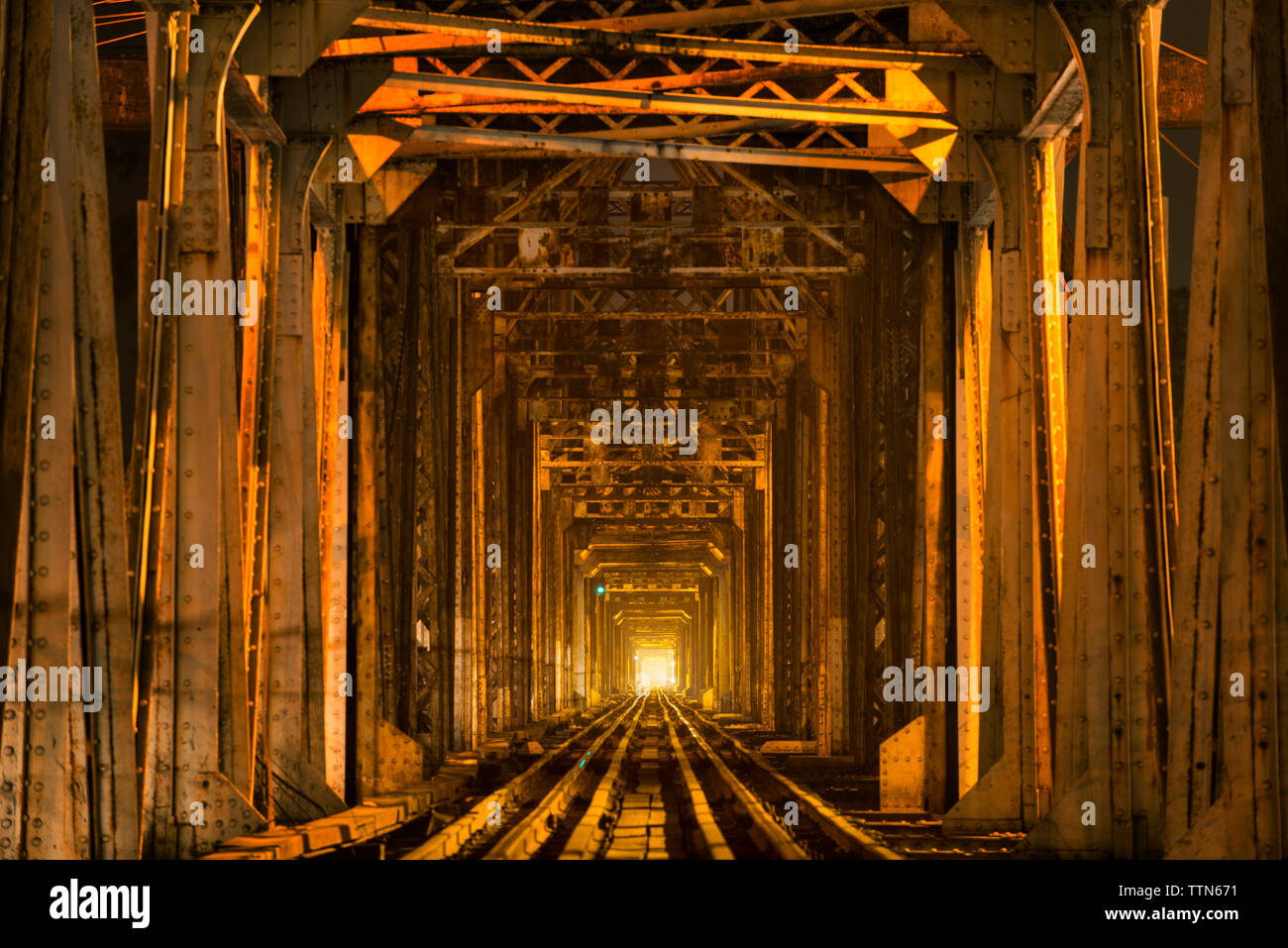 Railroad track in illuminated tunnel Stock Photo