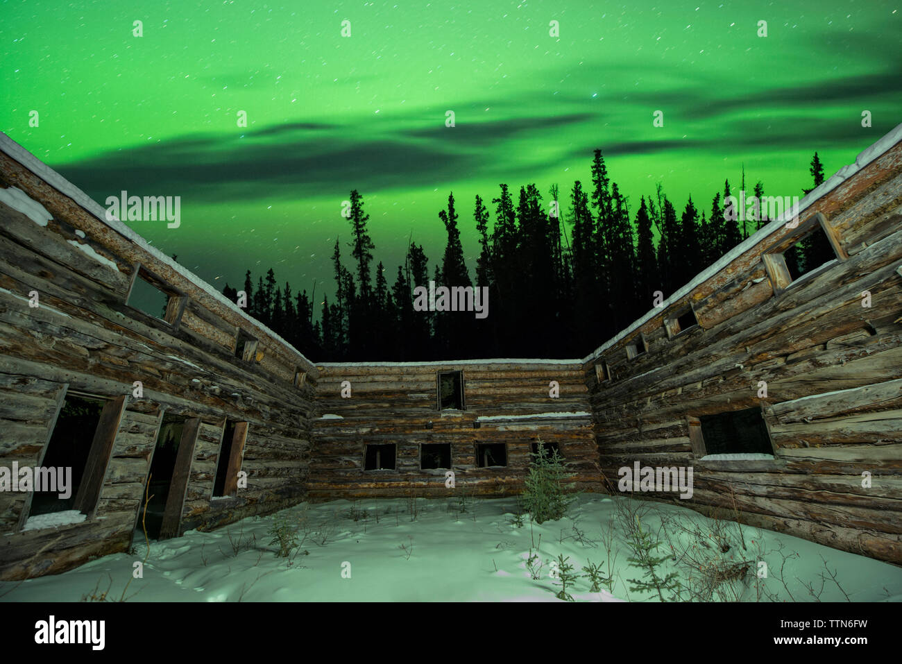 Majestic view of aurora borealis over wooden walls with windows Stock ...