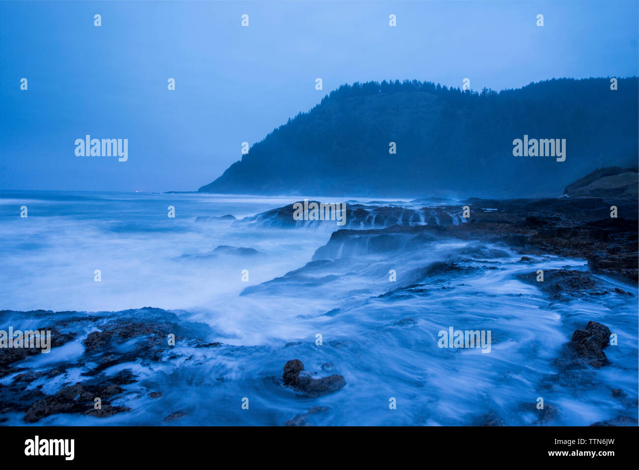 Scenic view of Thor's Well against sky during foggy weather Stock Photo