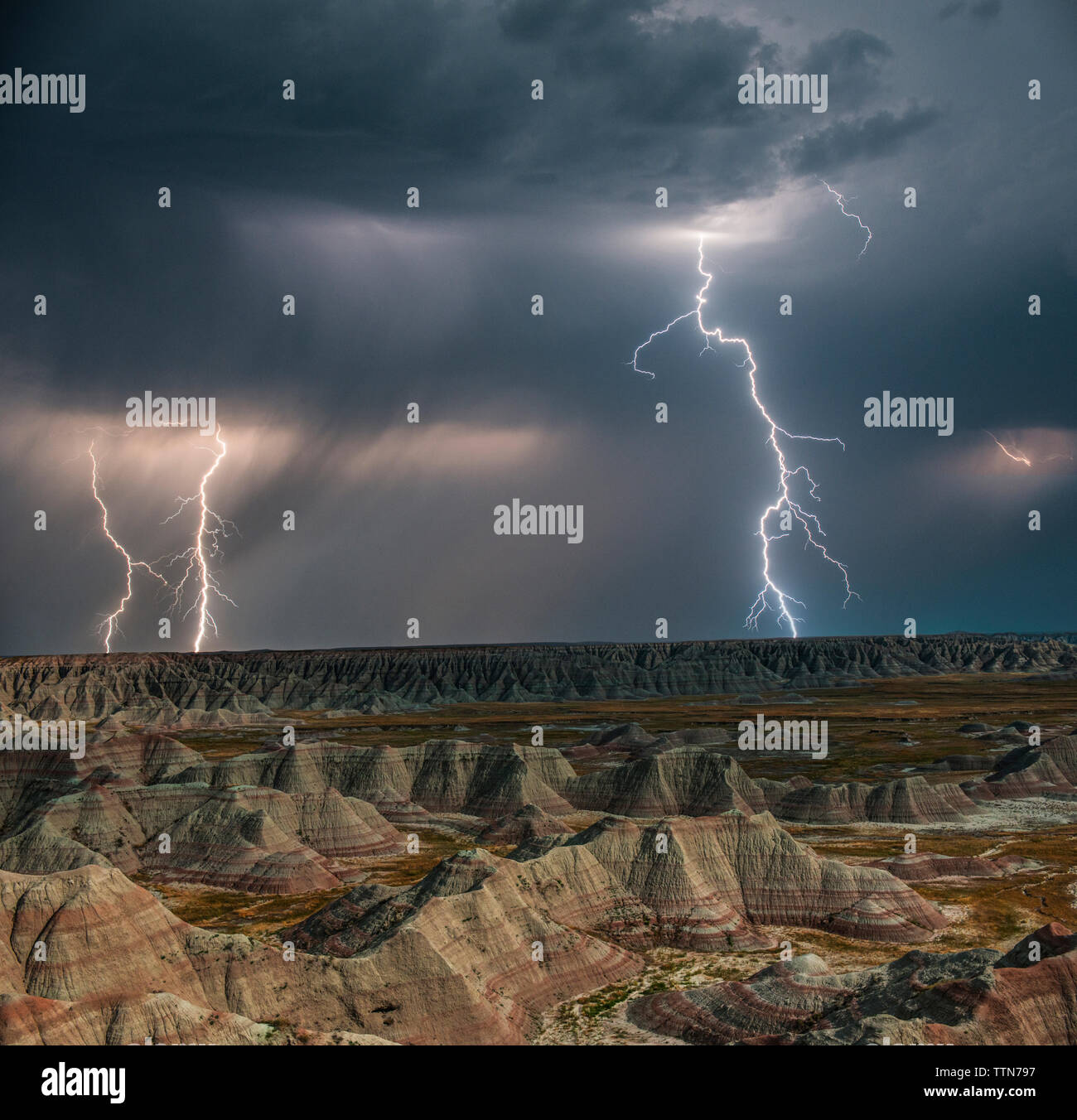 High angle majestic view of rock formations at Badlands National Park against thunderstorm and lightning Stock Photo
