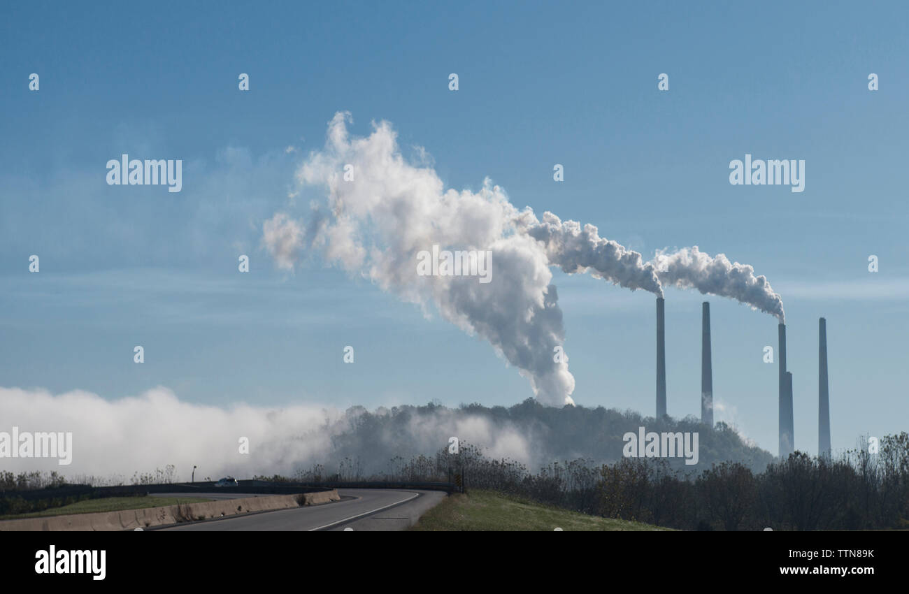 Smoke emitting from industry against sky Stock Photo