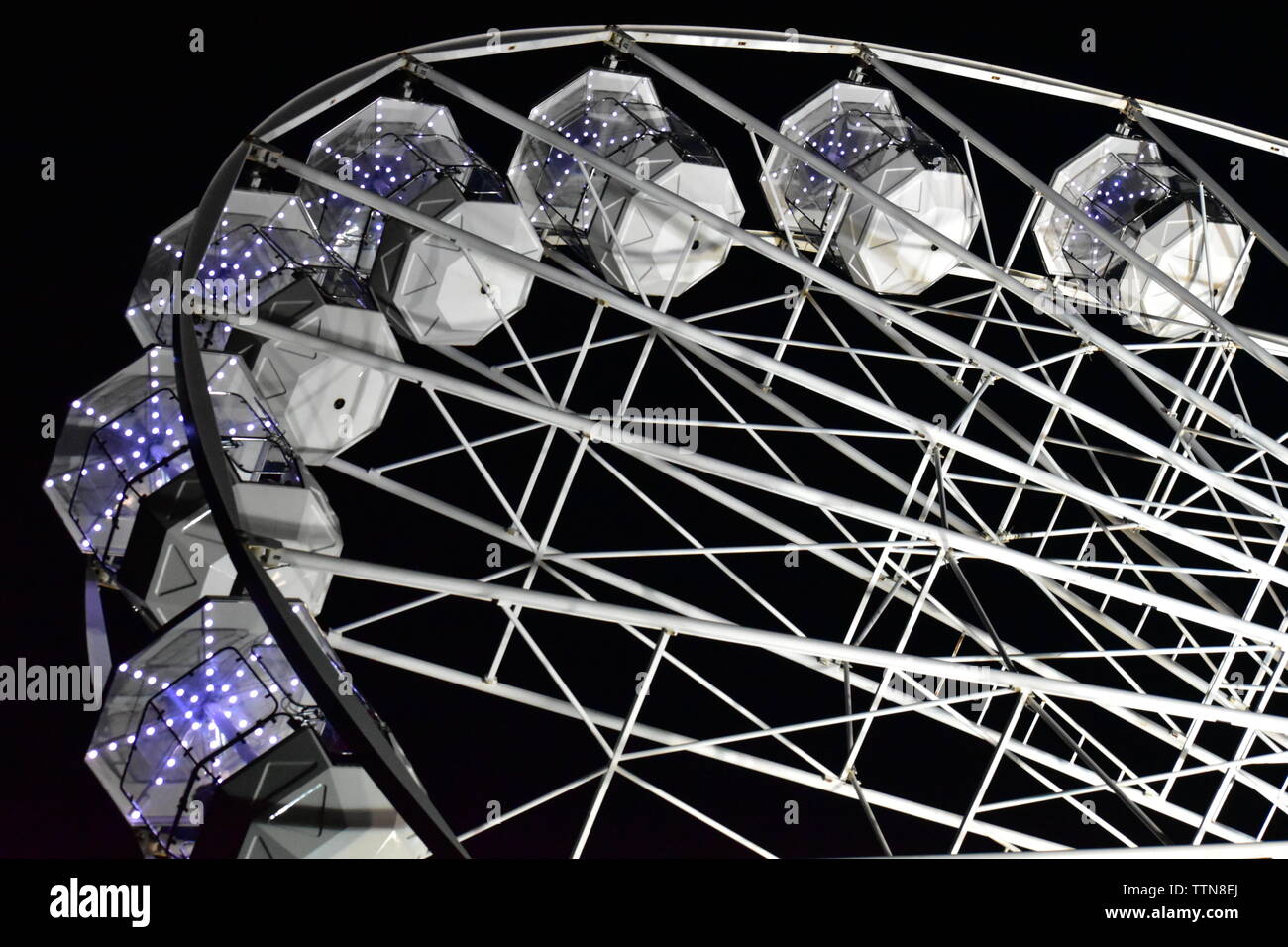 Newport, Isle of Wight - June 16 2019: Isle of Wight Festival Fairground ride, Ferris Wheel at night. Stock Photo
