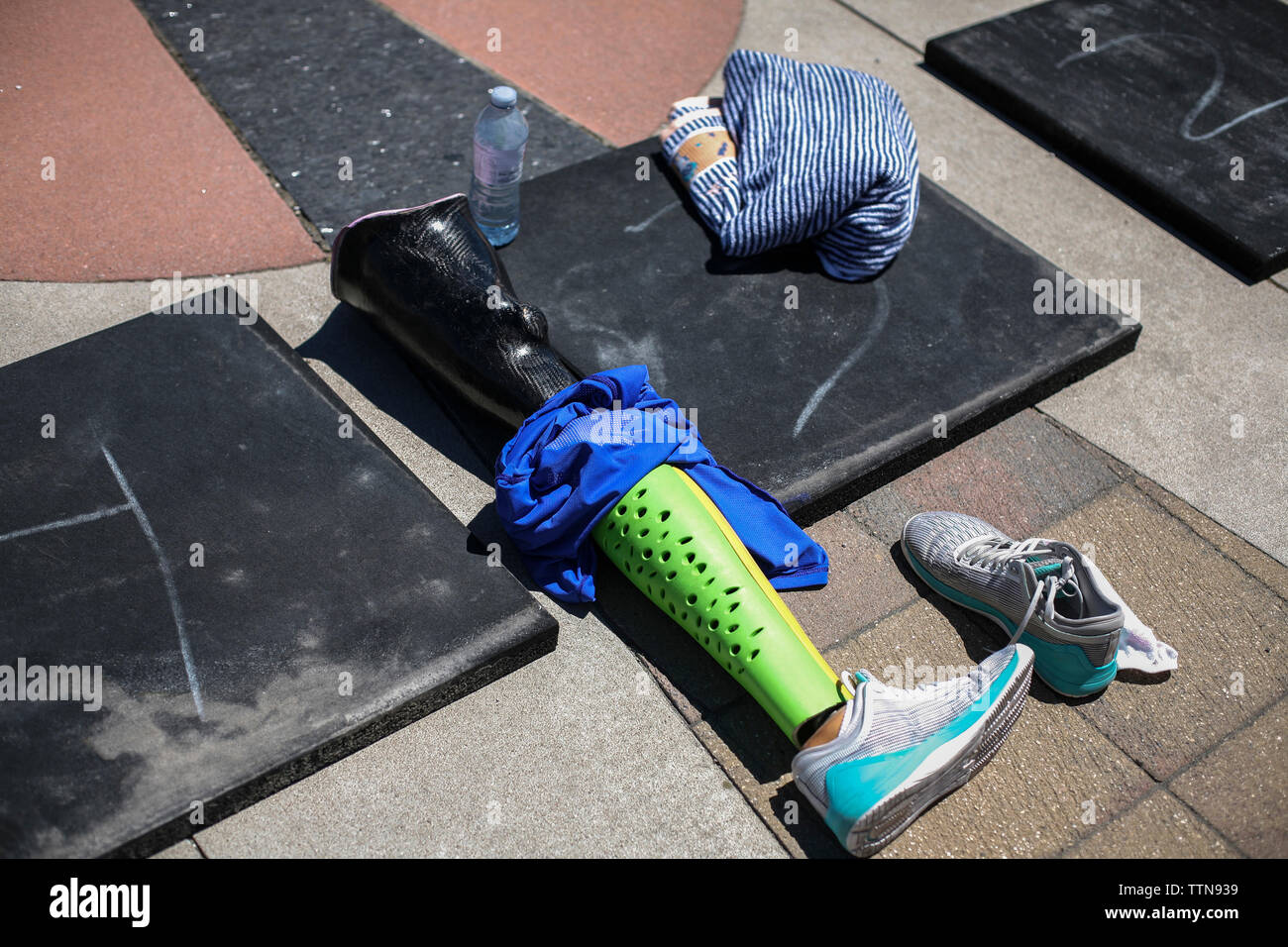 High angle view of prosthetic equipment with shoes and fabric on floor Stock Photo