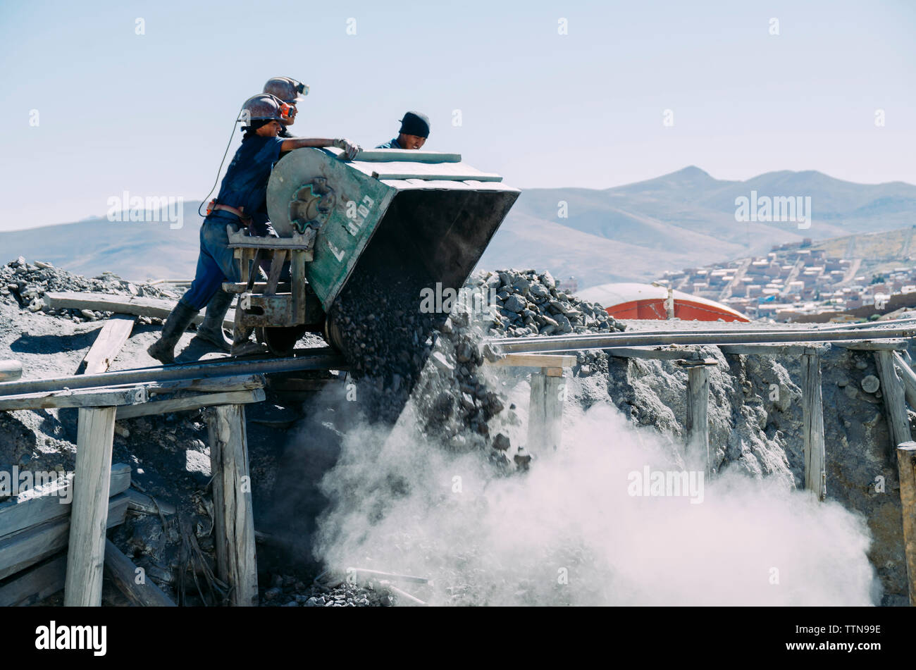 Workers dumping coal mines at construction site Stock Photo