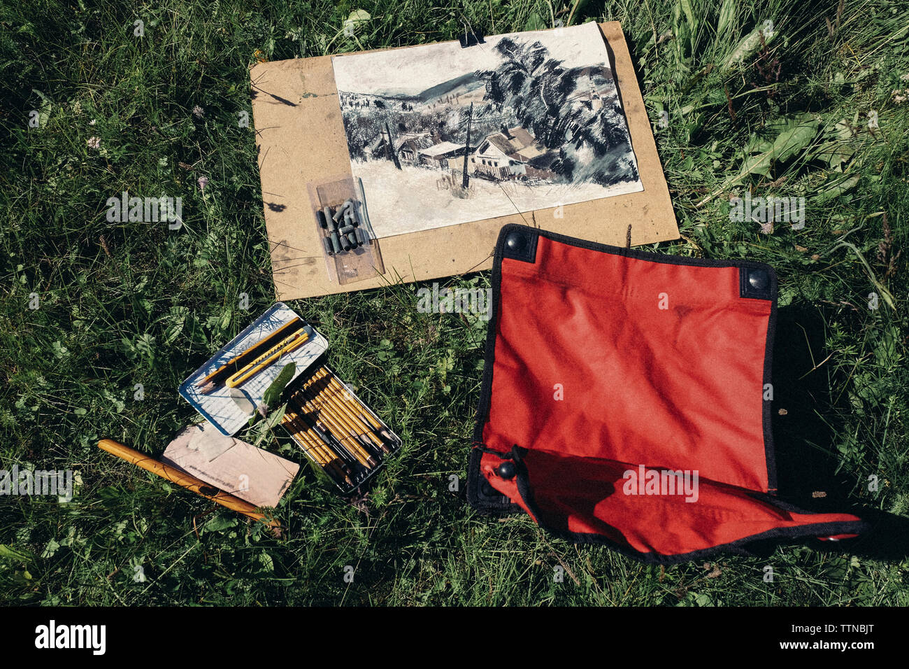 High angle view of art supplies on grassy field Stock Photo
