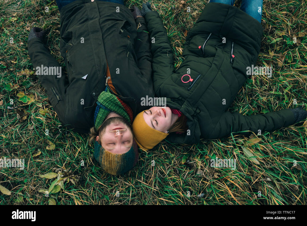 Man and woman lying on the grass Stock Photo - Alamy