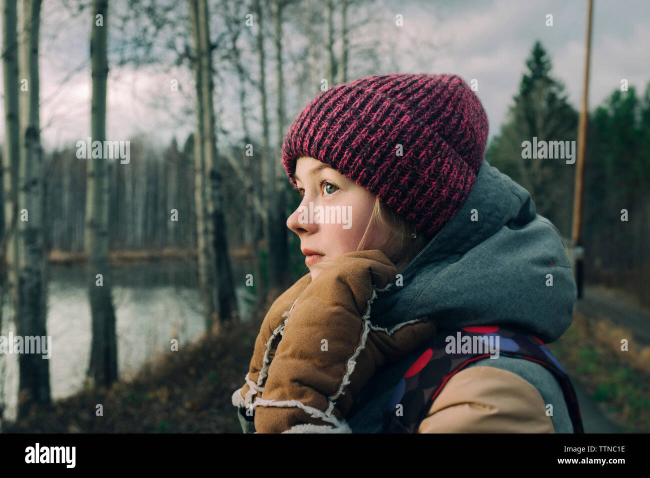 Beautiful girl in warm clothes in the forest Stock Photo Alamy