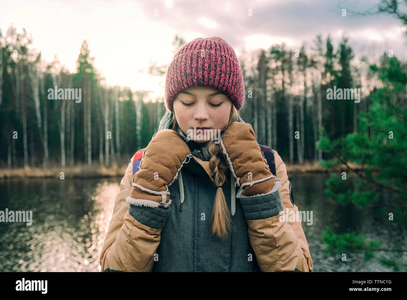 Portrait of young woman in warm clothes by the river Stock Photo
