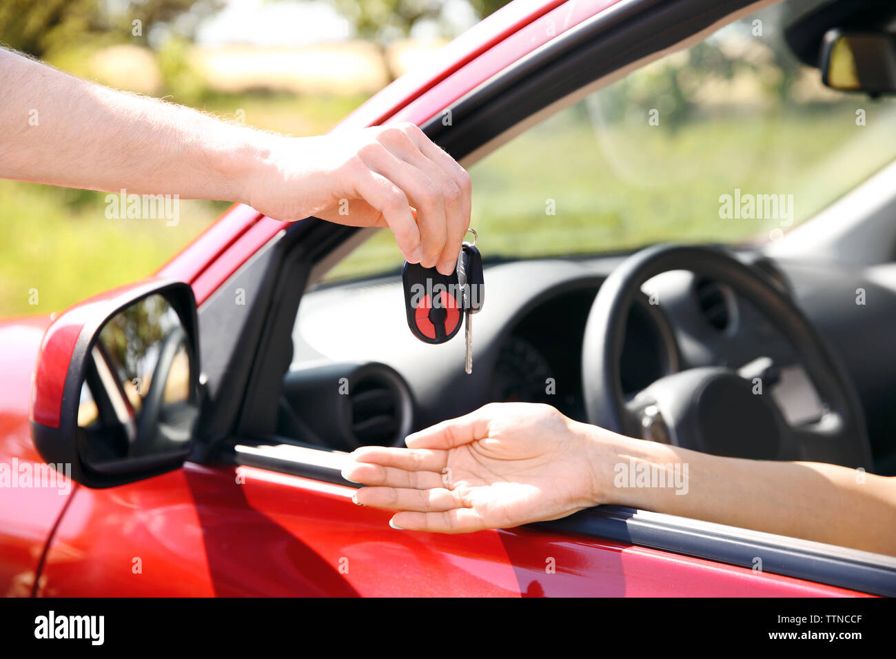 Hands passing car key Stock Photo Alamy