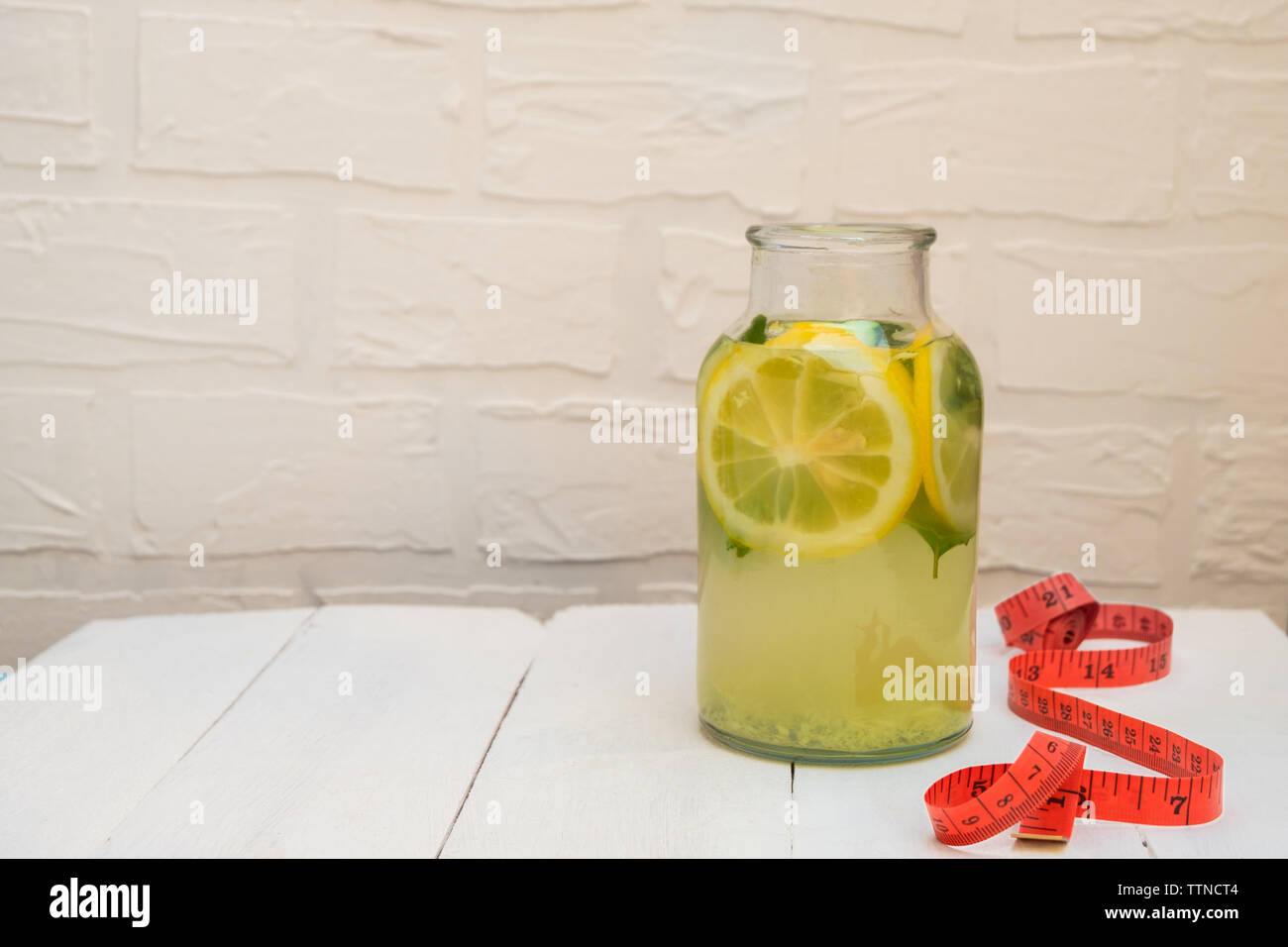 Detox Sassy Water in a jar on white wooden table with copy space Stock Photo