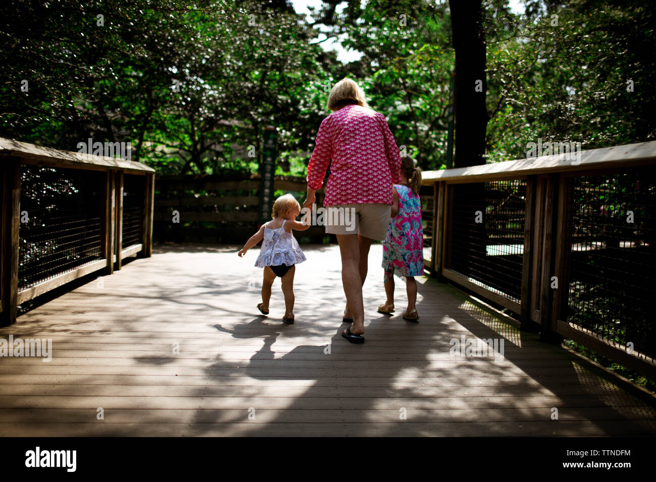 Grandmother and grandaughters walking outside in the summer Stock Photo