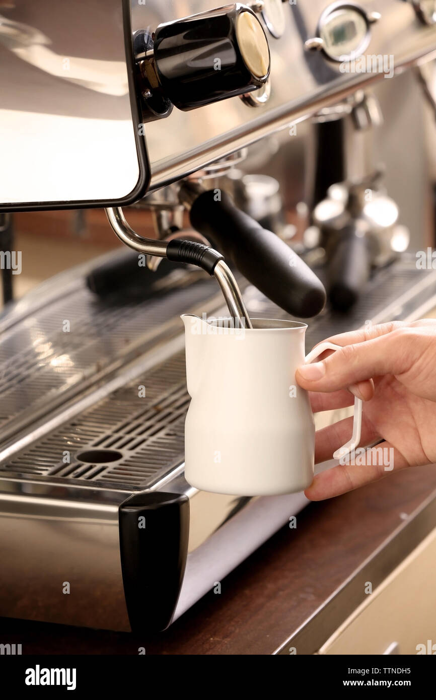 Barista whipping milk in coffee machine Stock Photo Alamy