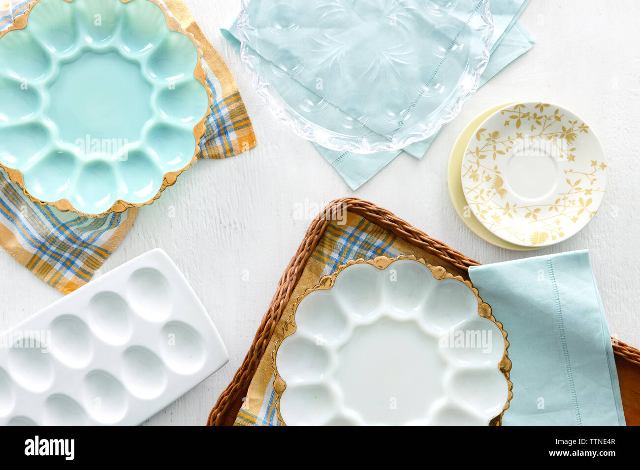 High angle view of egg shaped empty plates with napkins and tray on table at home Stock Photo