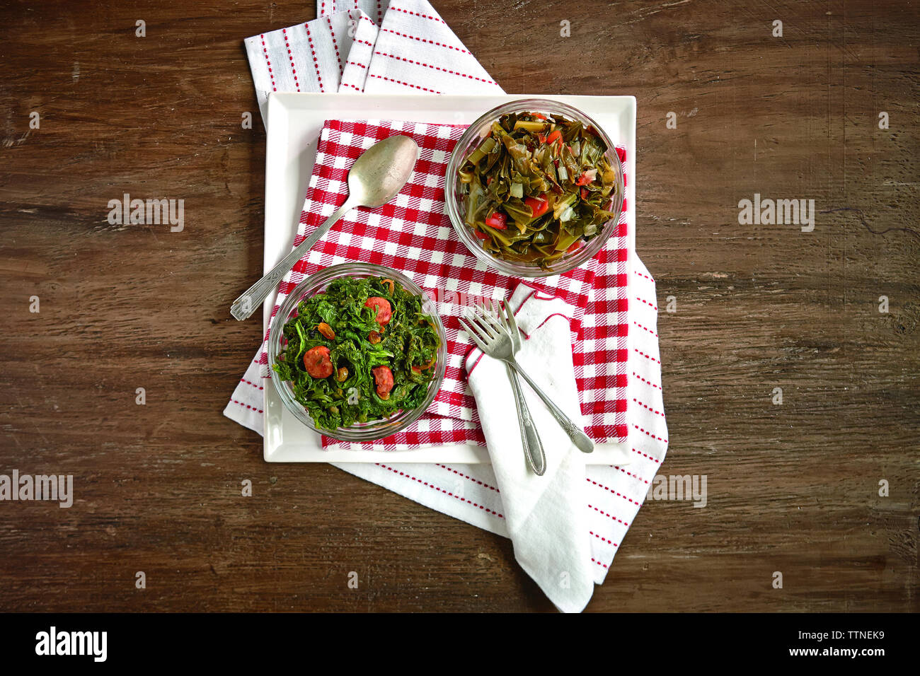 High angle view of cooked food in bowls on wooden table Stock Photo