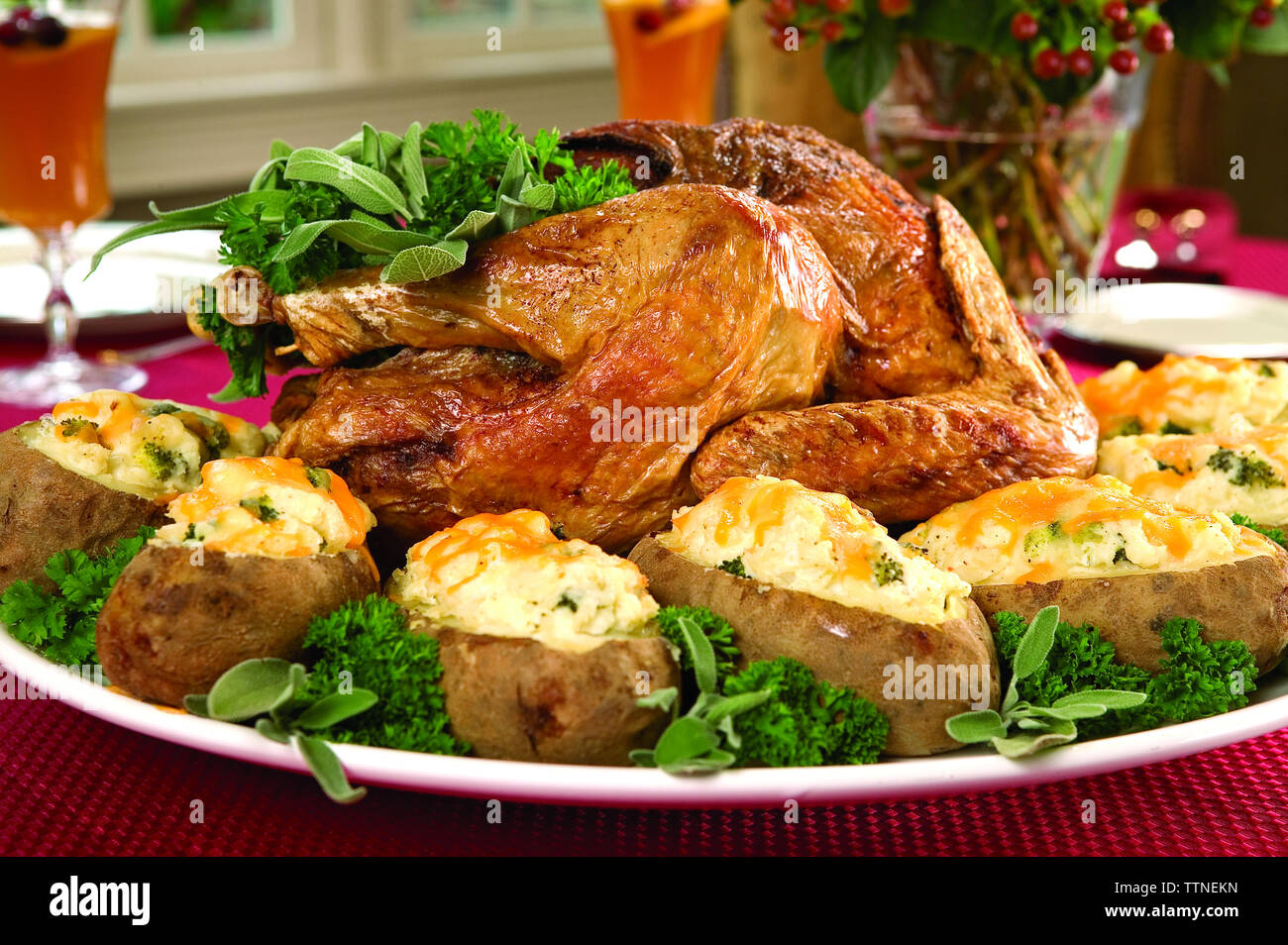 Close-up of roasted turkey meat with boiled potatoes and herbs on dining table at home Stock Photo