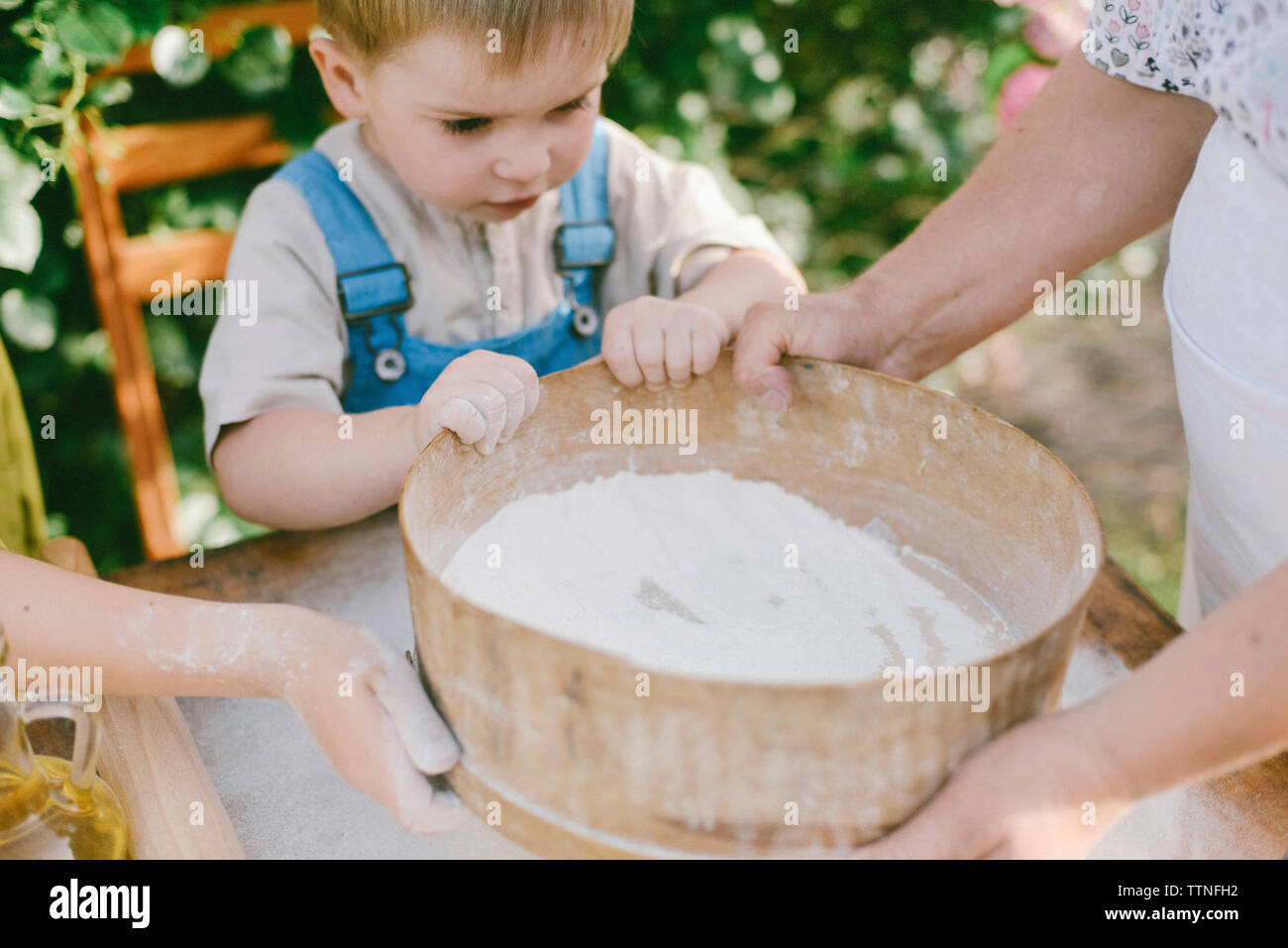 High angle view of family preparing food while standing in yard Stock Photo