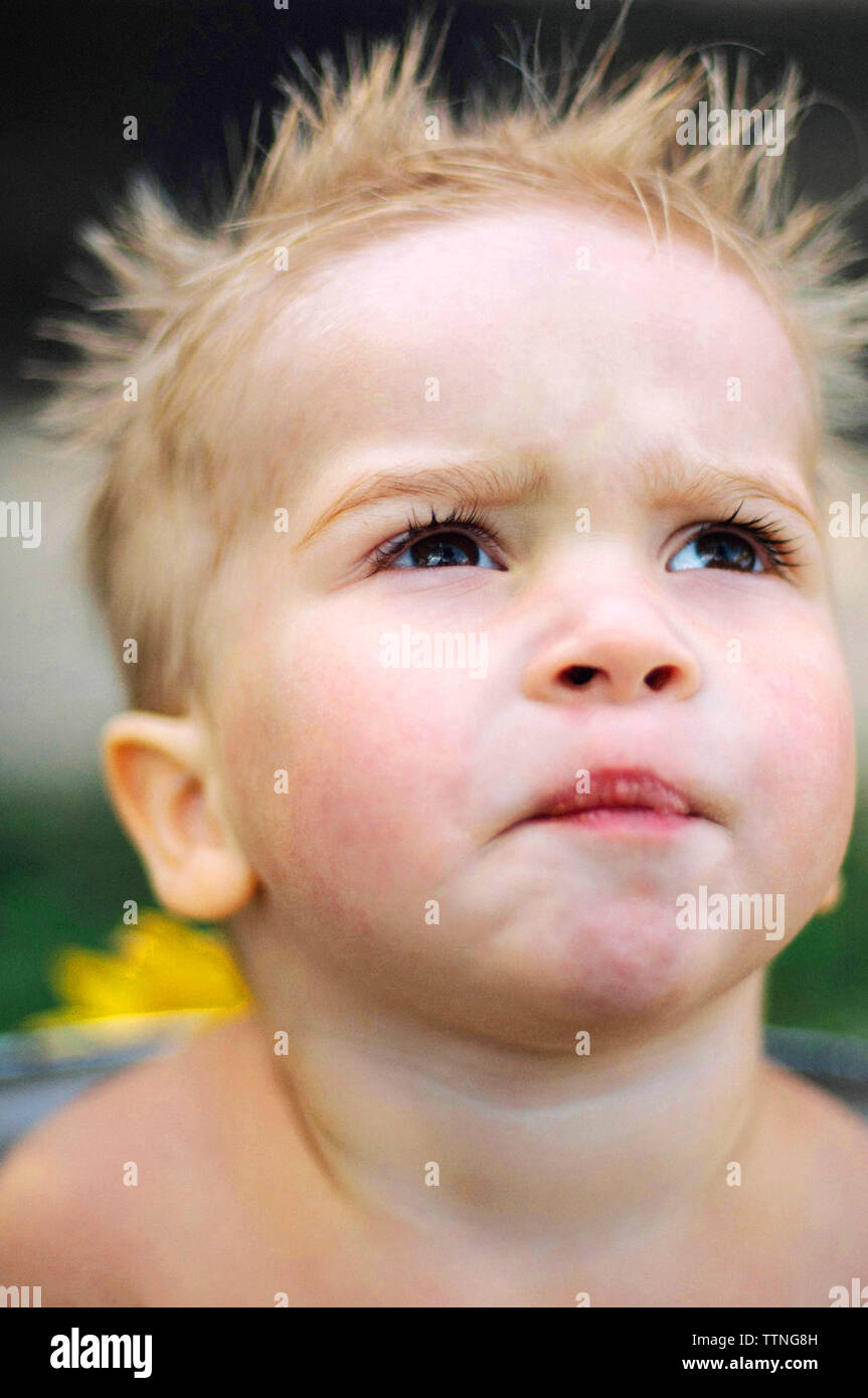 A baby boy takes a bath in the backyard, his mom washes her hair. Stock Photo