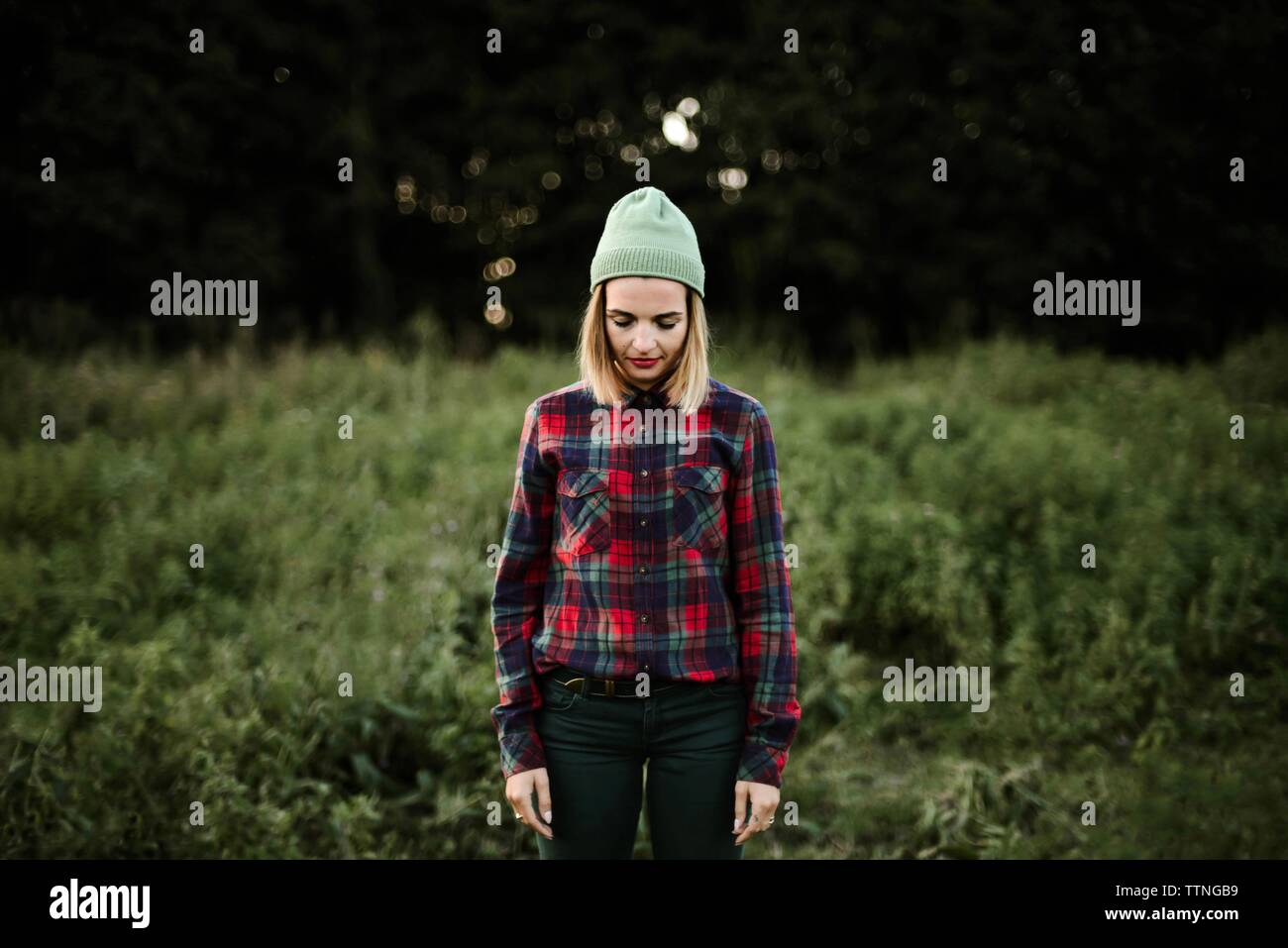 Young beautiful hipster woman standing on field in the countryside Stock Photo