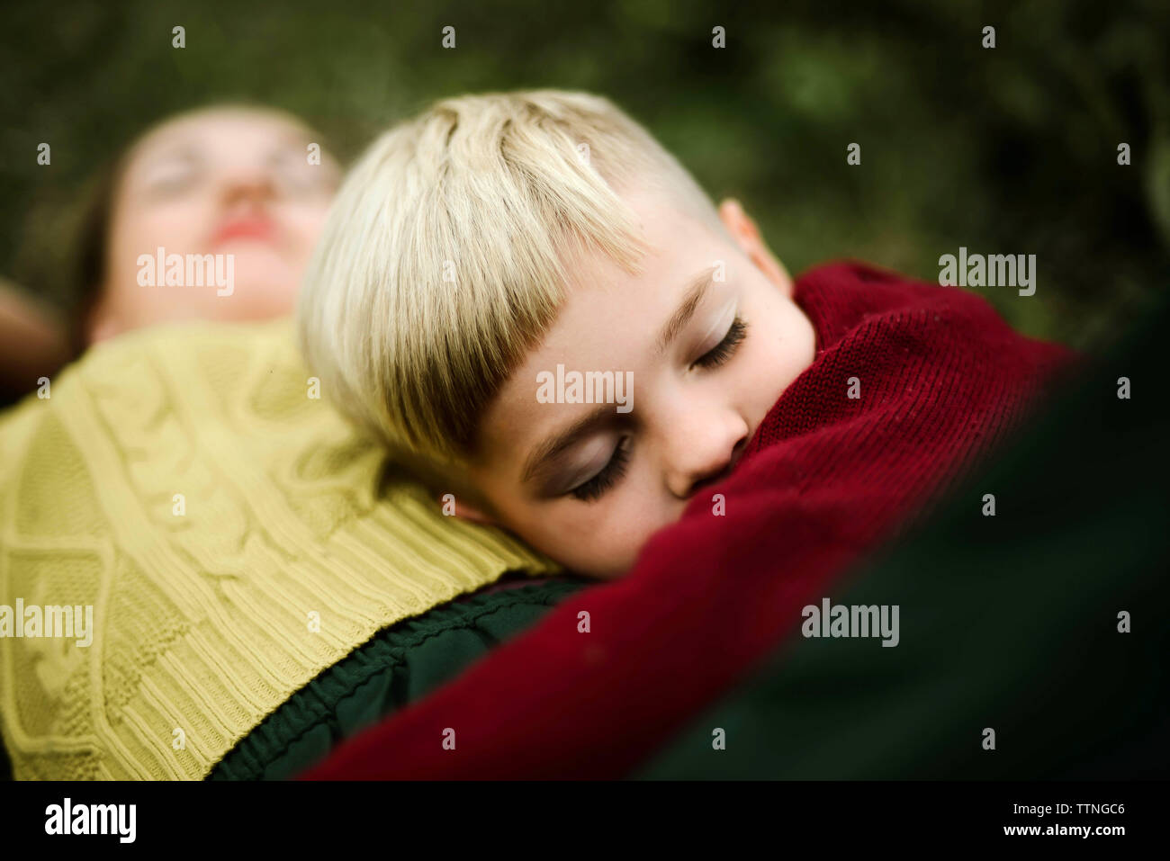 Son embracing mother on field in the countryside Stock Photo